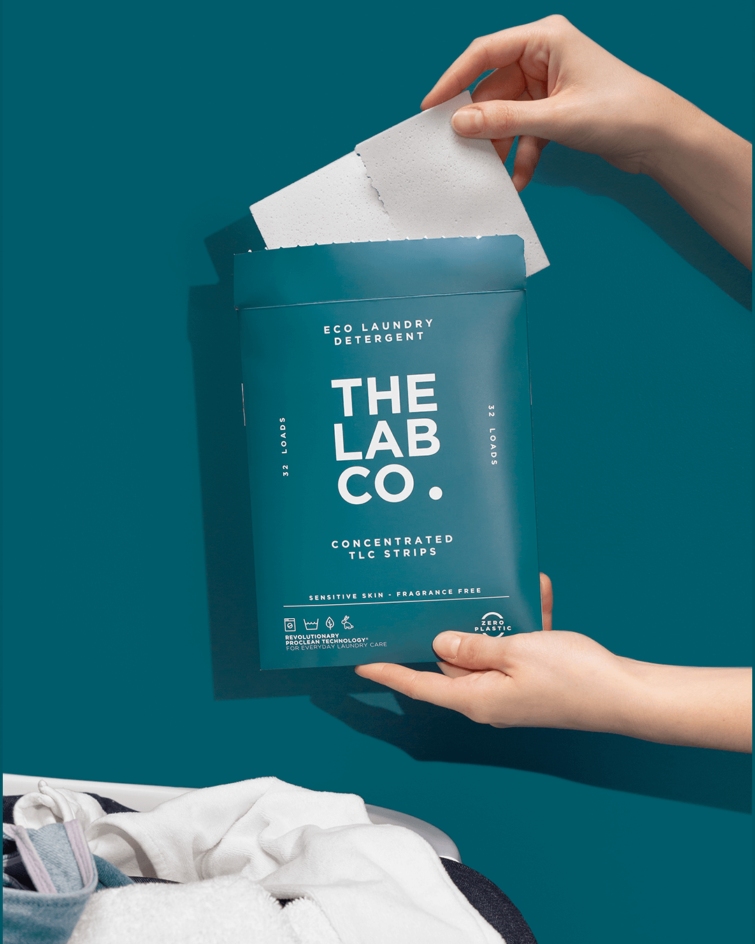 hands holding TLC fragrance free laundry strips product image